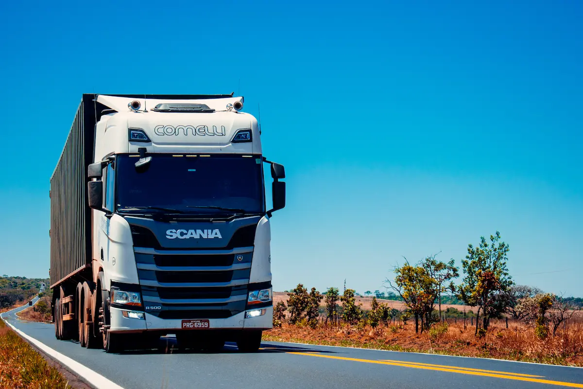 Camion Scania transportând utilaje agricole second hand pe șosea europeană către România